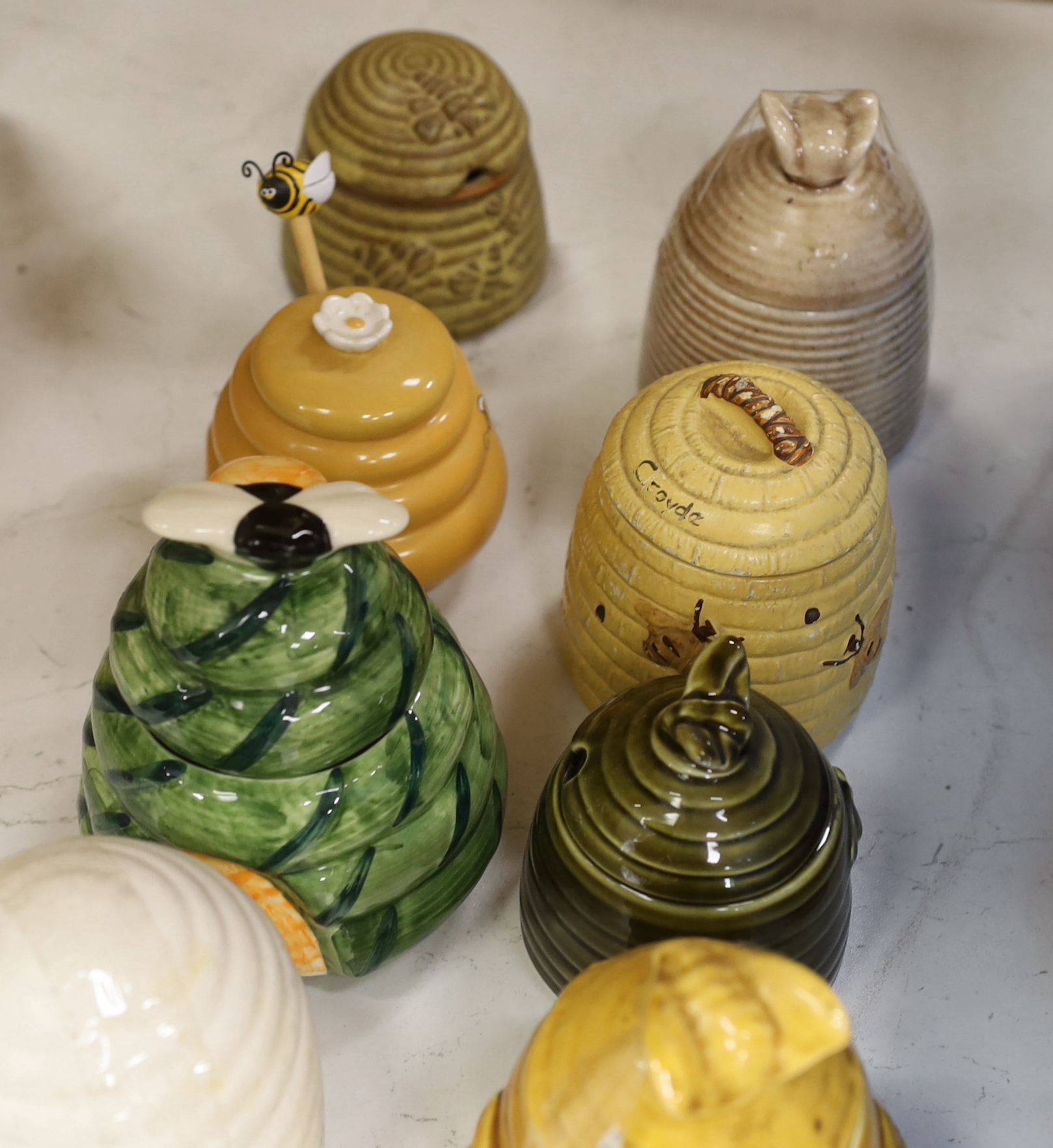 Fifteen various glazed honey jars and covers, largest 14cm high